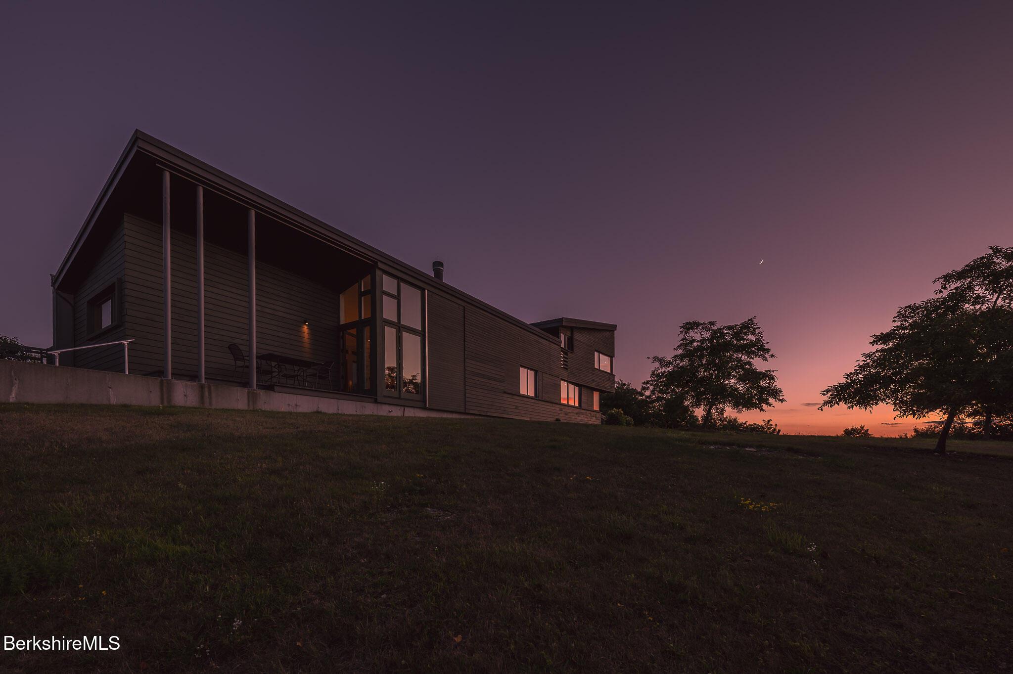 Image 1: Exterior At Sunset