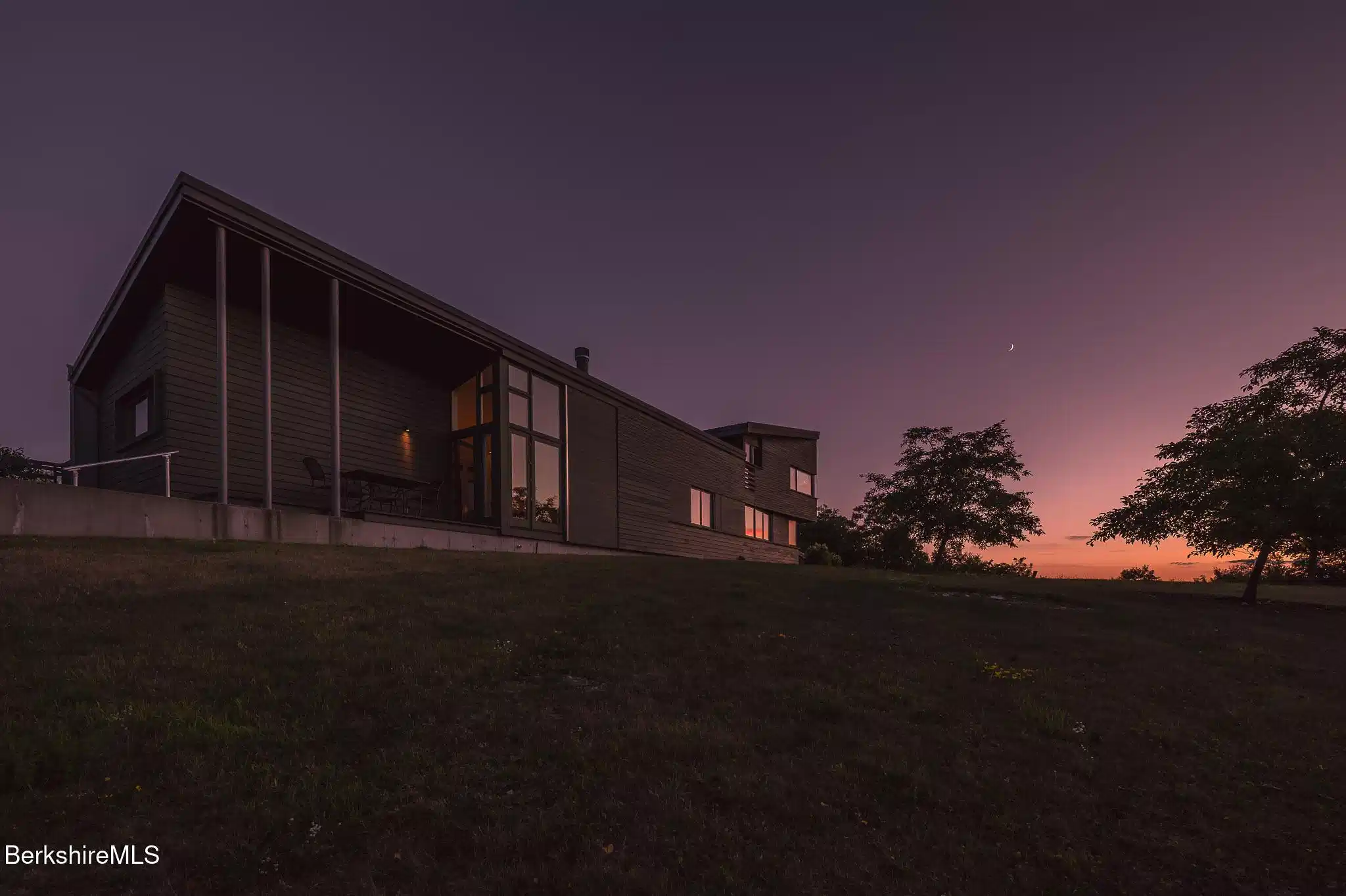 Image 1: Exterior At Sunset