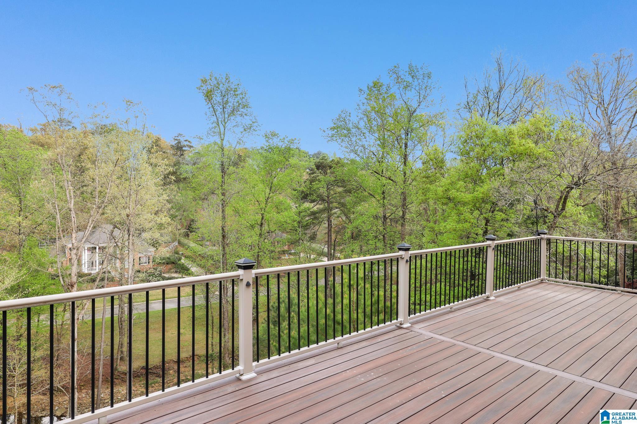Image 3: Main Level Porch with Wooded Creek View