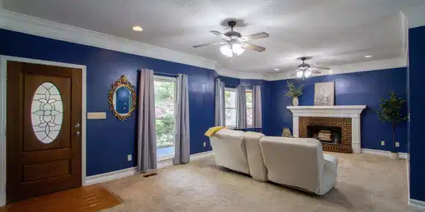 Image 3: Spacious living room with wood burning fireplace