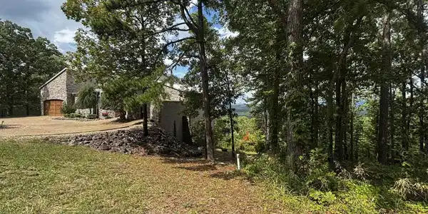 Image 2: House to the left of the lot