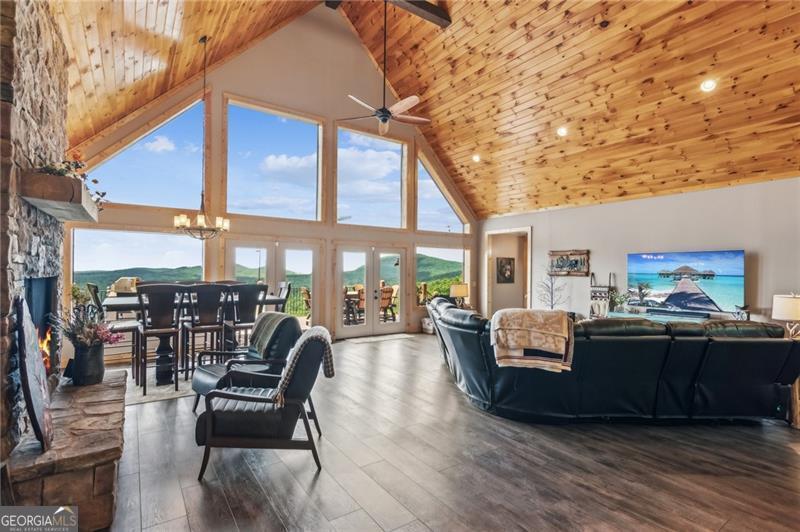 Image 3 Living area featuring high vaulted ceiling, woode
