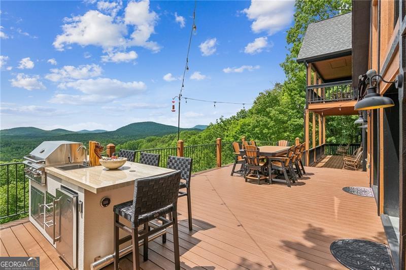 Image 4 Wooden terrace with outdoor dining area, a mounta
