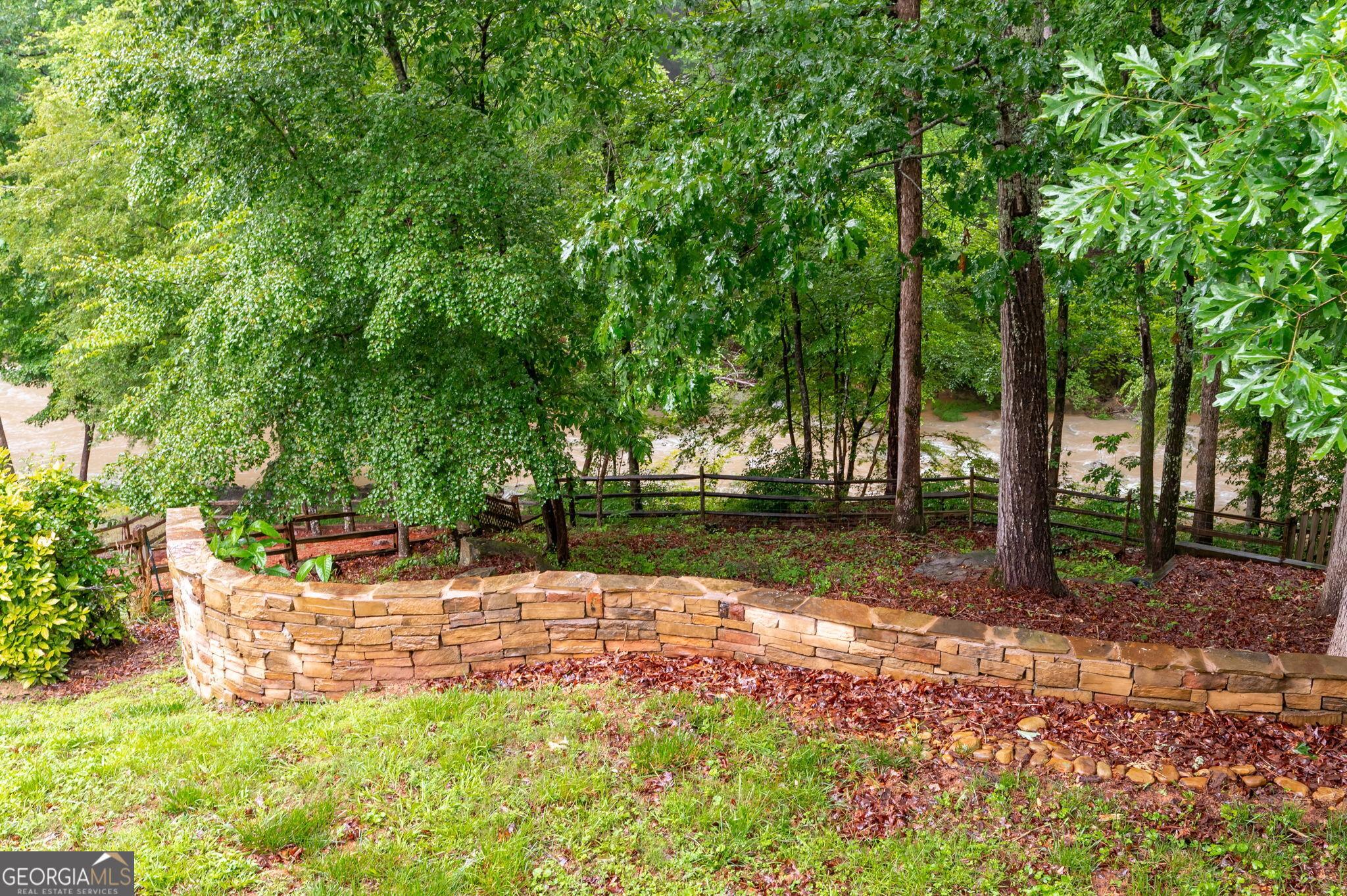 Image 3: Gorgeous stone wall in backyard and Pumpkinvine Creek
