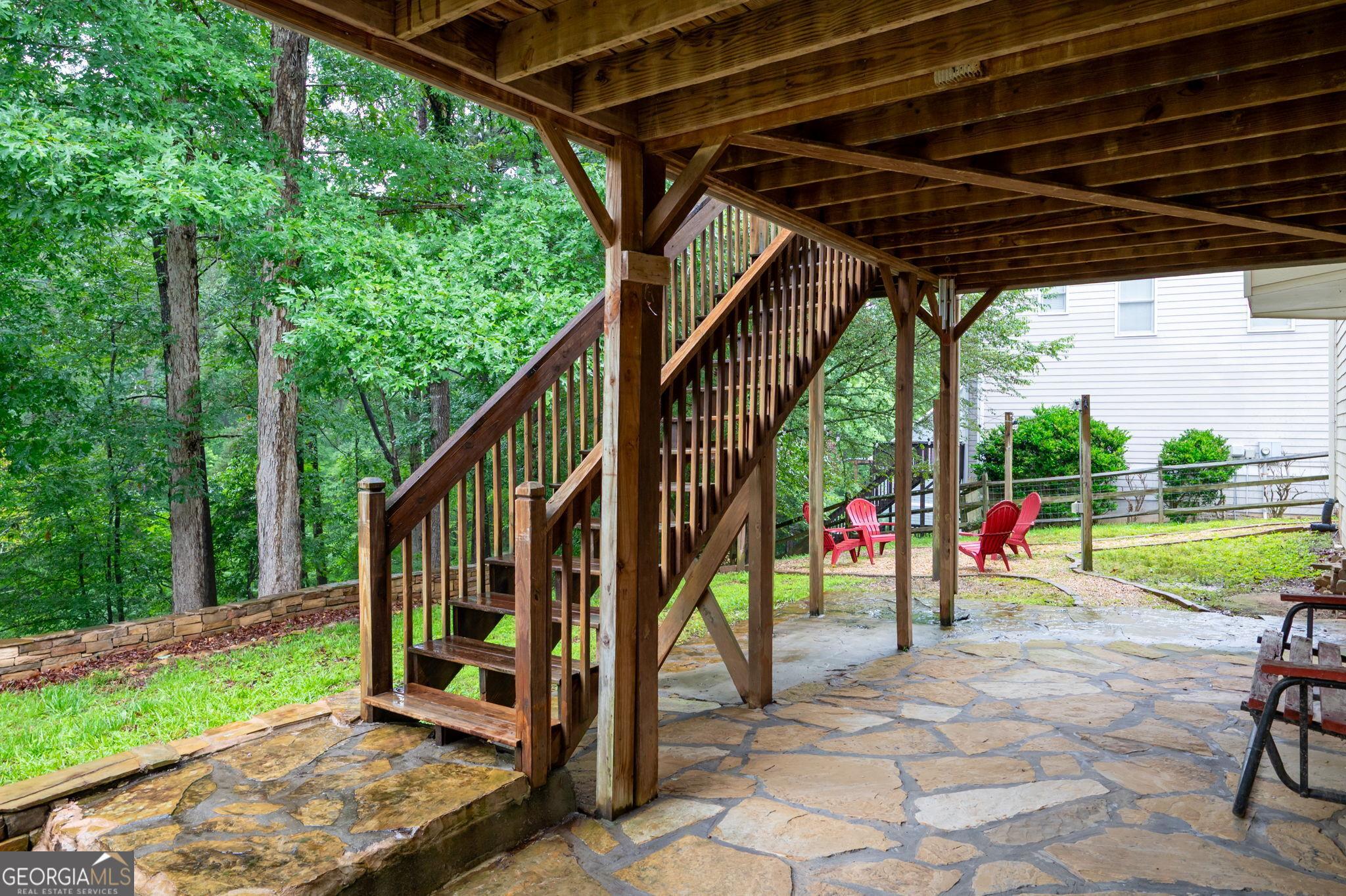Image 4: Stairs from screen porch down to stone patio