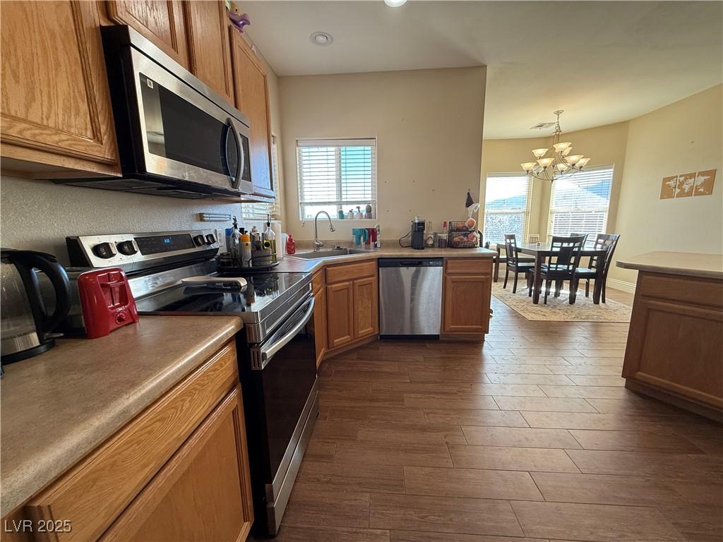 Image 3: Kitchen with stainless steel appliances and garden