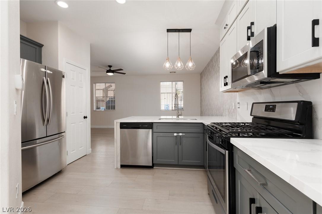 Image 3: A well-lit kitchen with sleek stainless steel appl