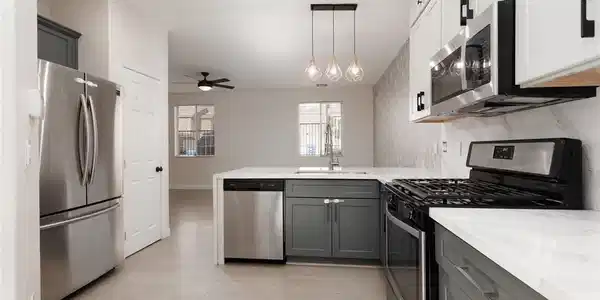 Image 3: A well-lit kitchen with sleek stainless steel appl