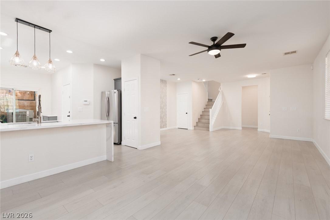 Image 4: An open concept living space with light-toned hard