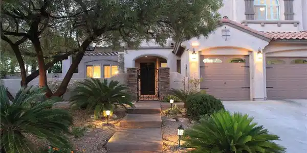 Image 3: A welcoming entry path leads to a home adorned wit