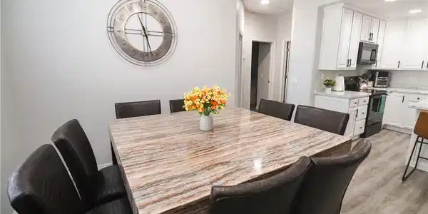 Image 3: Seamless flow between the dining and kitchen. This