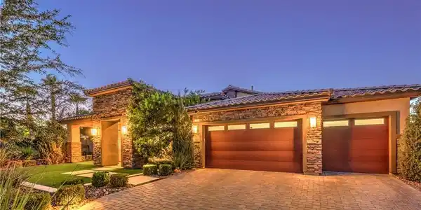 Image 2: A striking facade with warm exterior lighting and