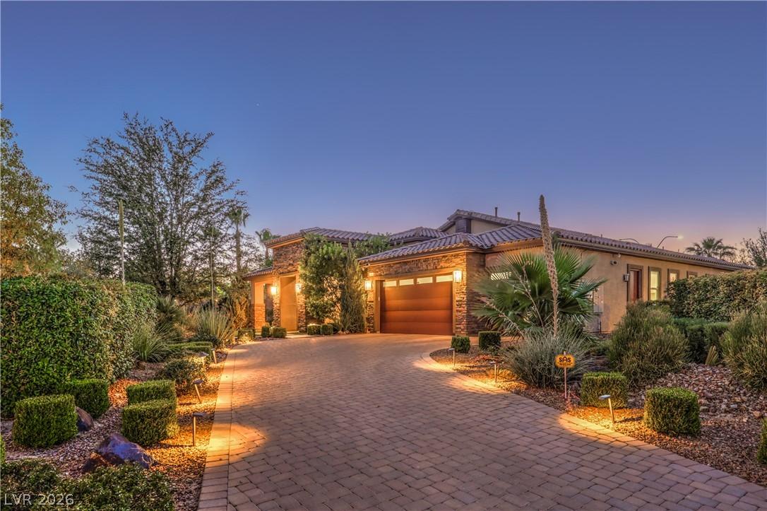 Image 4: An inviting brick paver driveway leads to a warm,