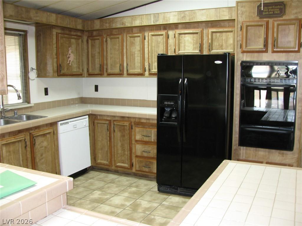 Image 4: An inviting kitchen featuring warm wood cabinetry