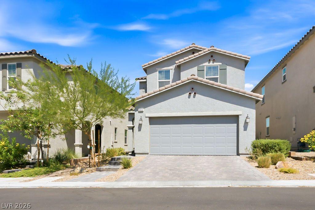 Image 2: A well-maintained facade with an attached garage a
