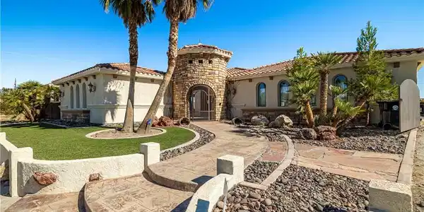 Image 3: A grand entrance with a stone-clad turret and iron