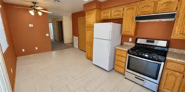 Image 4: Ample wooden cabinetry and ceramic tile flooring d