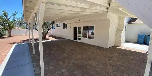 Image 2: This inviting patio area features durable paver fl