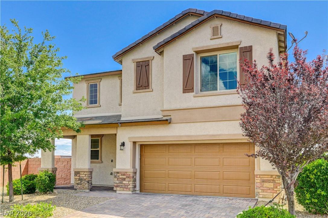 Image 2: A welcoming facade with a tan stucco finish and br