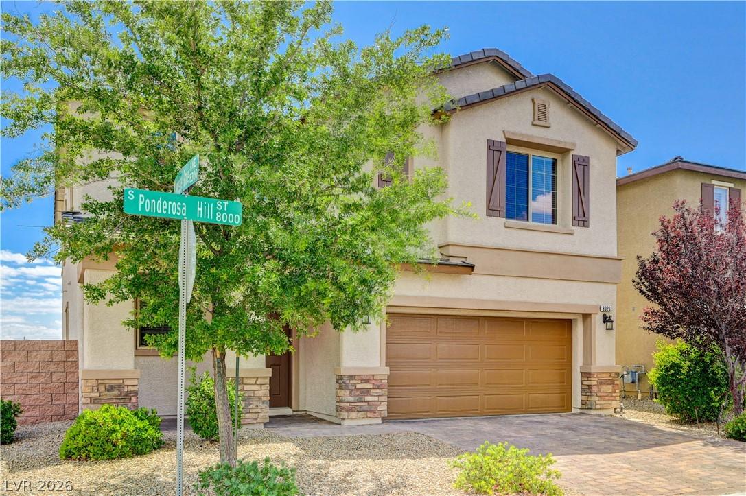 Image 4: A classic two-story residence with a tan stucco ex