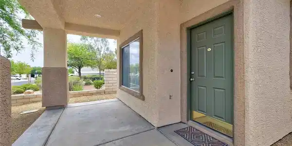 Image 4: A welcoming covered porch with recessed lighting i