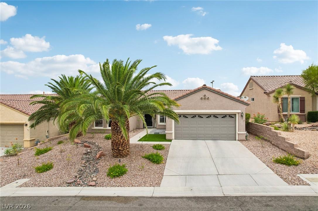 Image 1: A desert oasis with a well-maintained xeriscaped f