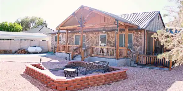 Image 4: A charming stone and wood exterior with a covered