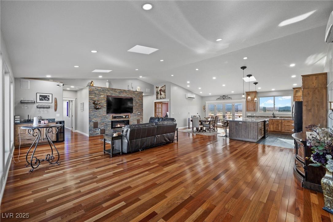 Image 4: Living room featuring vaulted ceiling with skyligh