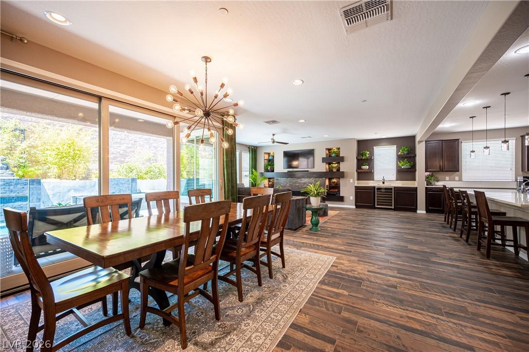 Image 4: This open-concept living space boasts wood-look fl