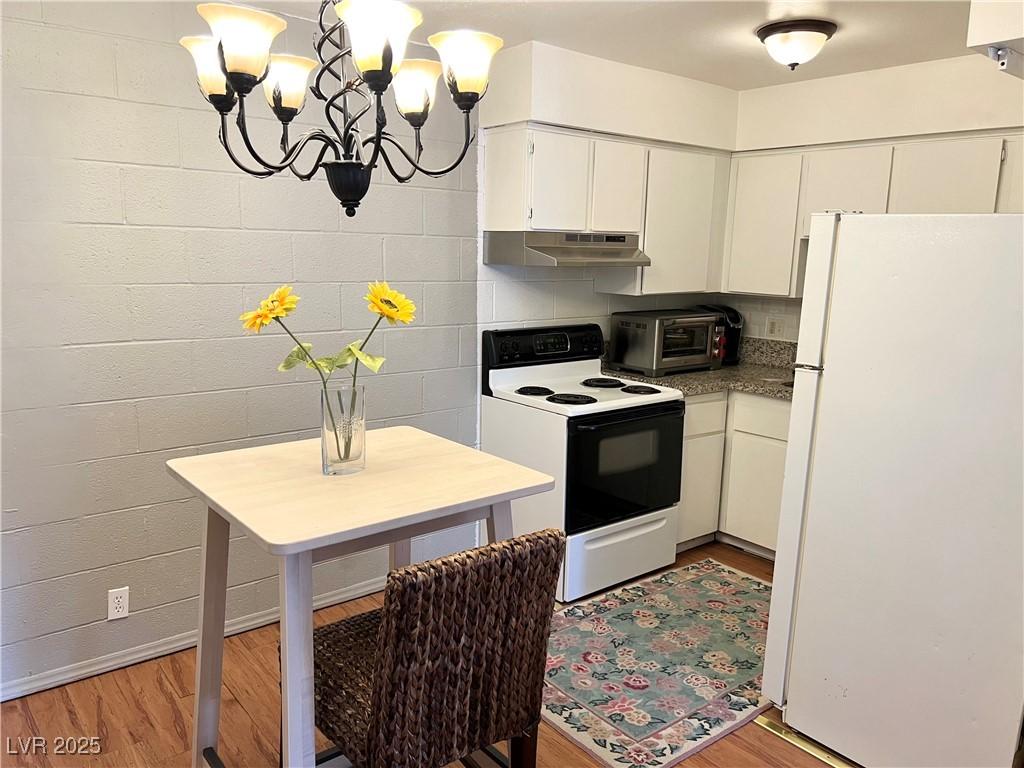 Image 4: Kitchen with a toaster, under cabinet range hood,