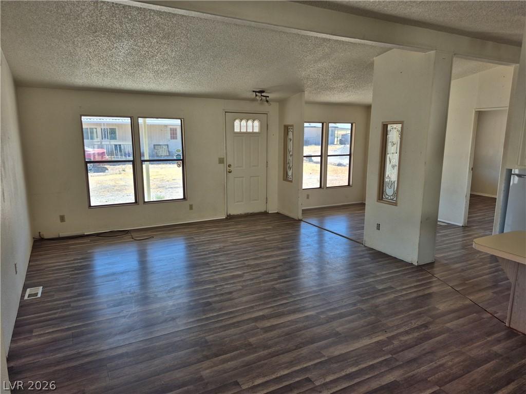 Image 4: Rich wood flooring extends through this welcoming