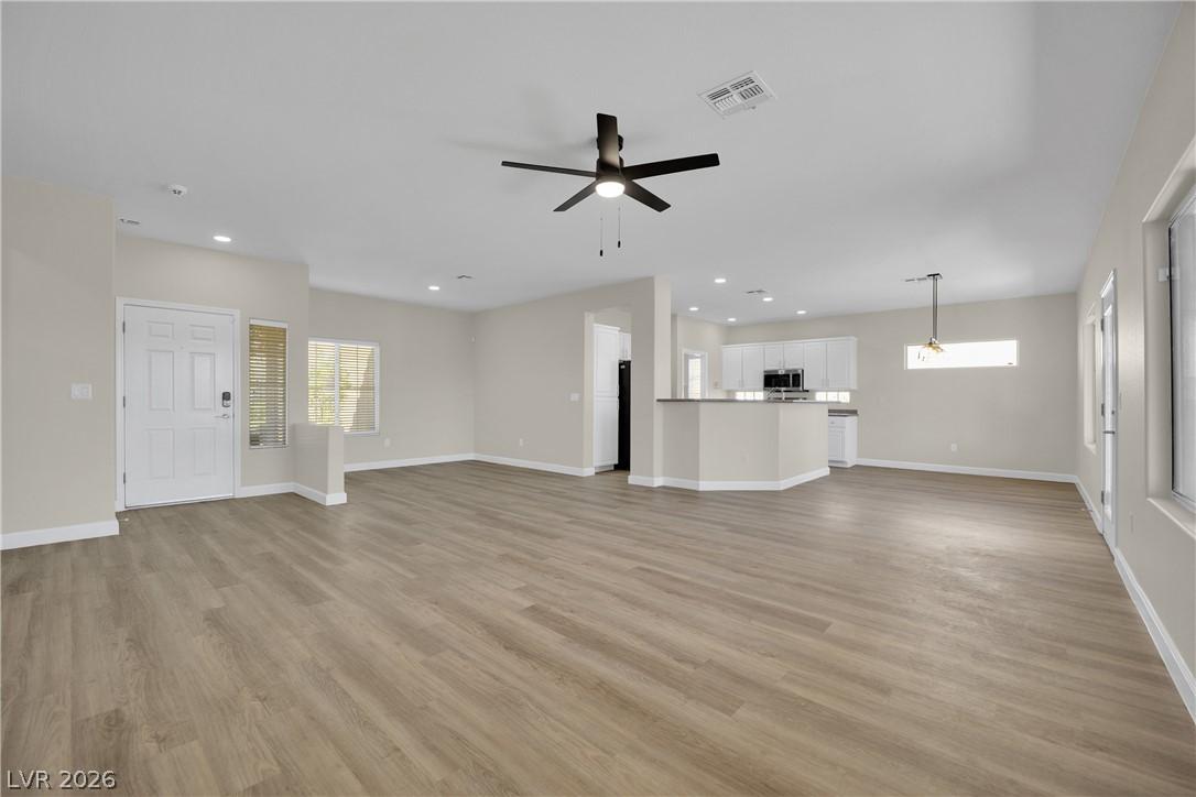 Image 2: A spacious, open-concept interior featuring light