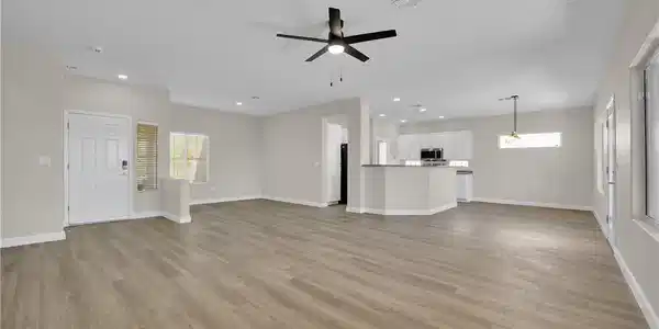 Image 2: A spacious, open-concept interior featuring light