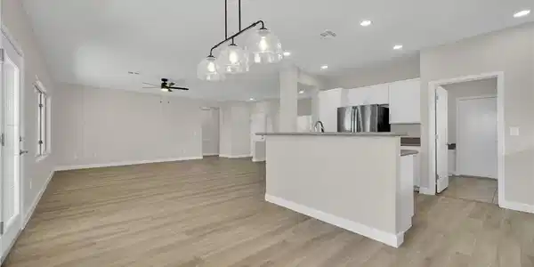 Image 3: An open floorplan living area flows seamlessly int