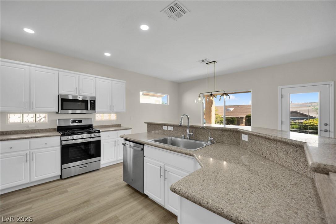 Image 4: A well-appointed kitchen features ample counter sp
