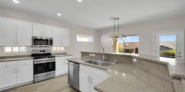 Image 4: A well-appointed kitchen features ample counter sp