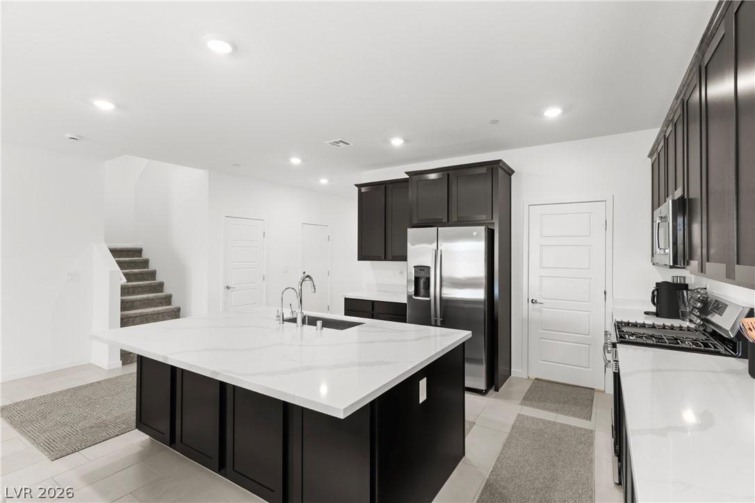 Image 2: A well-appointed kitchen showcasing a spacious cen