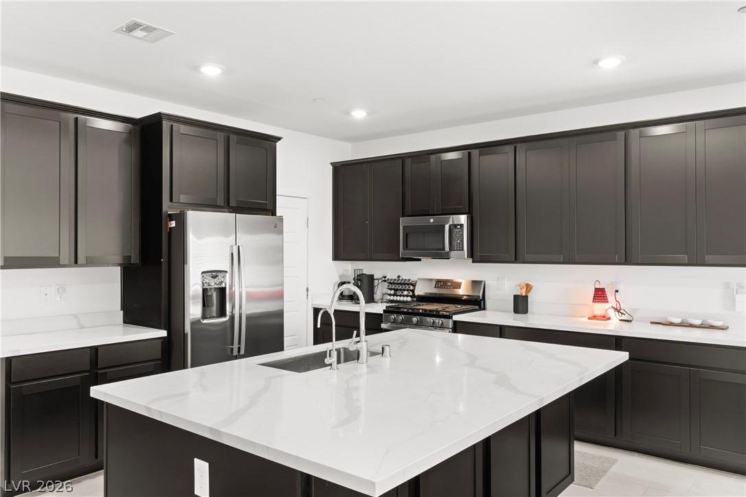 Image 3: This kitchen showcases a central island and contem