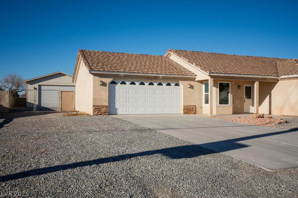 Image 2: Ranch-style house with stucco siding and concrete