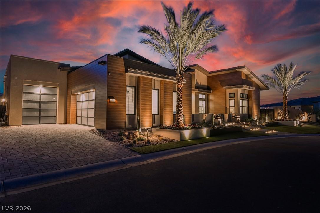 Image 2: Dramatic sunset over a modern facade with luminous