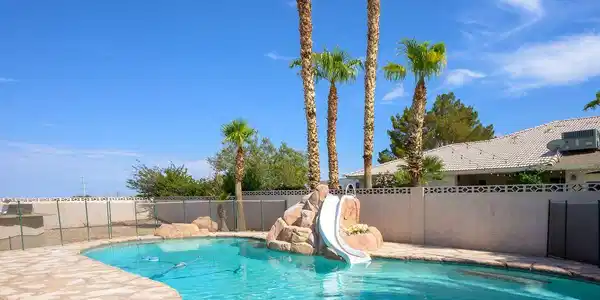 Image 4: A private, resort-style backyard offers a sparklin