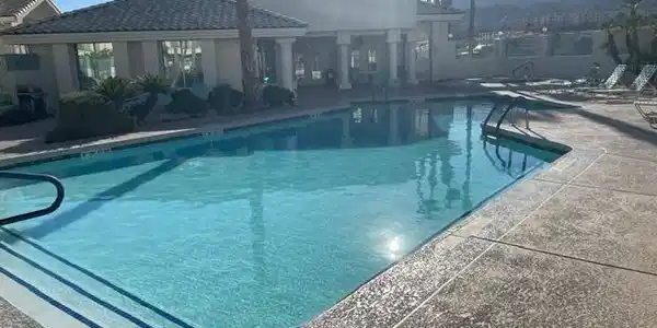 Image 2: A sparkling pool invites relaxation, set against a