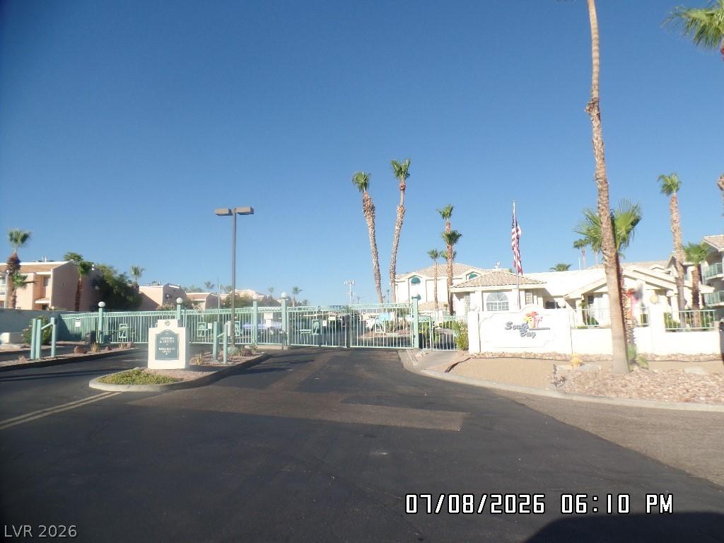 Image 4: Secure community entrance with palm trees and a we