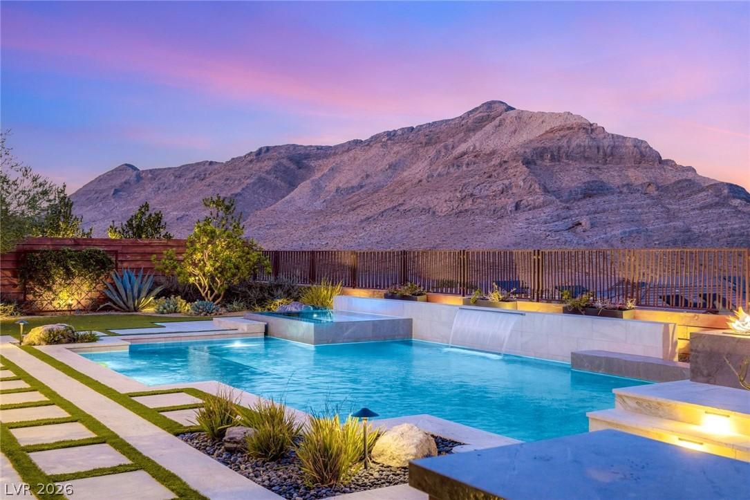 Image 1: An inviting backyard oasis features a shimmering p