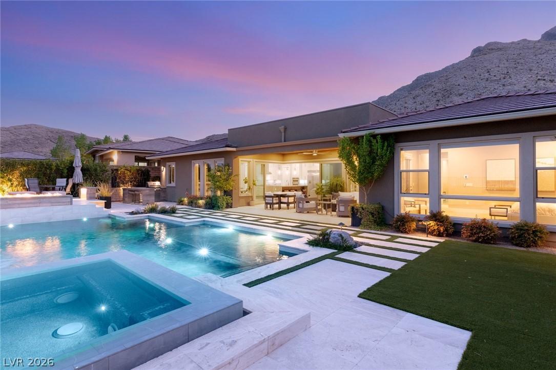 Image 3: An inviting backyard oasis offers a sparkling pool