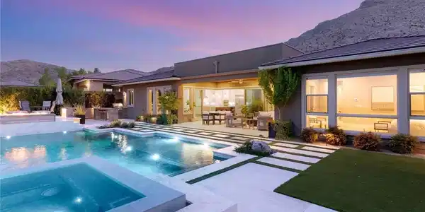 Image 3: An inviting backyard oasis offers a sparkling pool