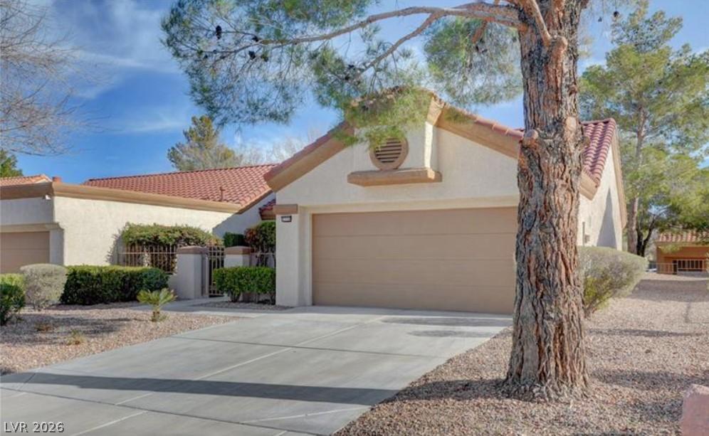 Image 2: A well-maintained concrete driveway leads to the a