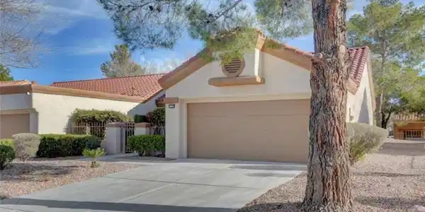 Image 2: A well-maintained concrete driveway leads to the a