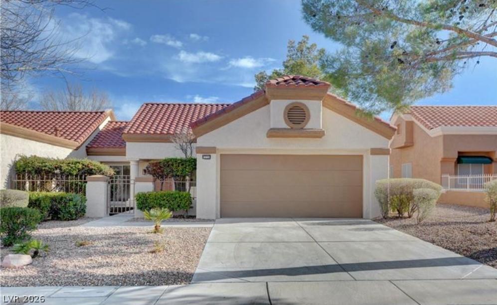 Image 3: A well-maintained stucco home with a tile roof and