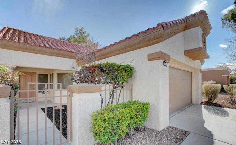 Image 4: A well-maintained stucco exterior with a tiled roo